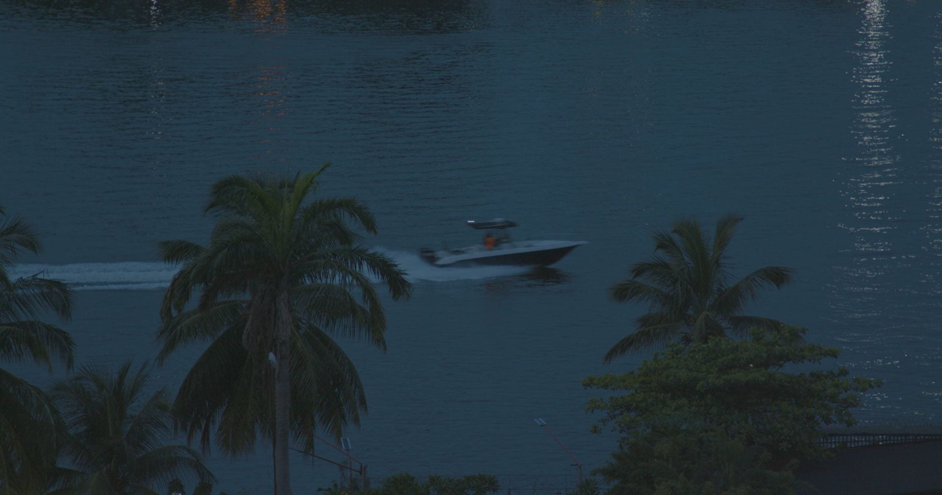 An image of a speedboat on some water at night.