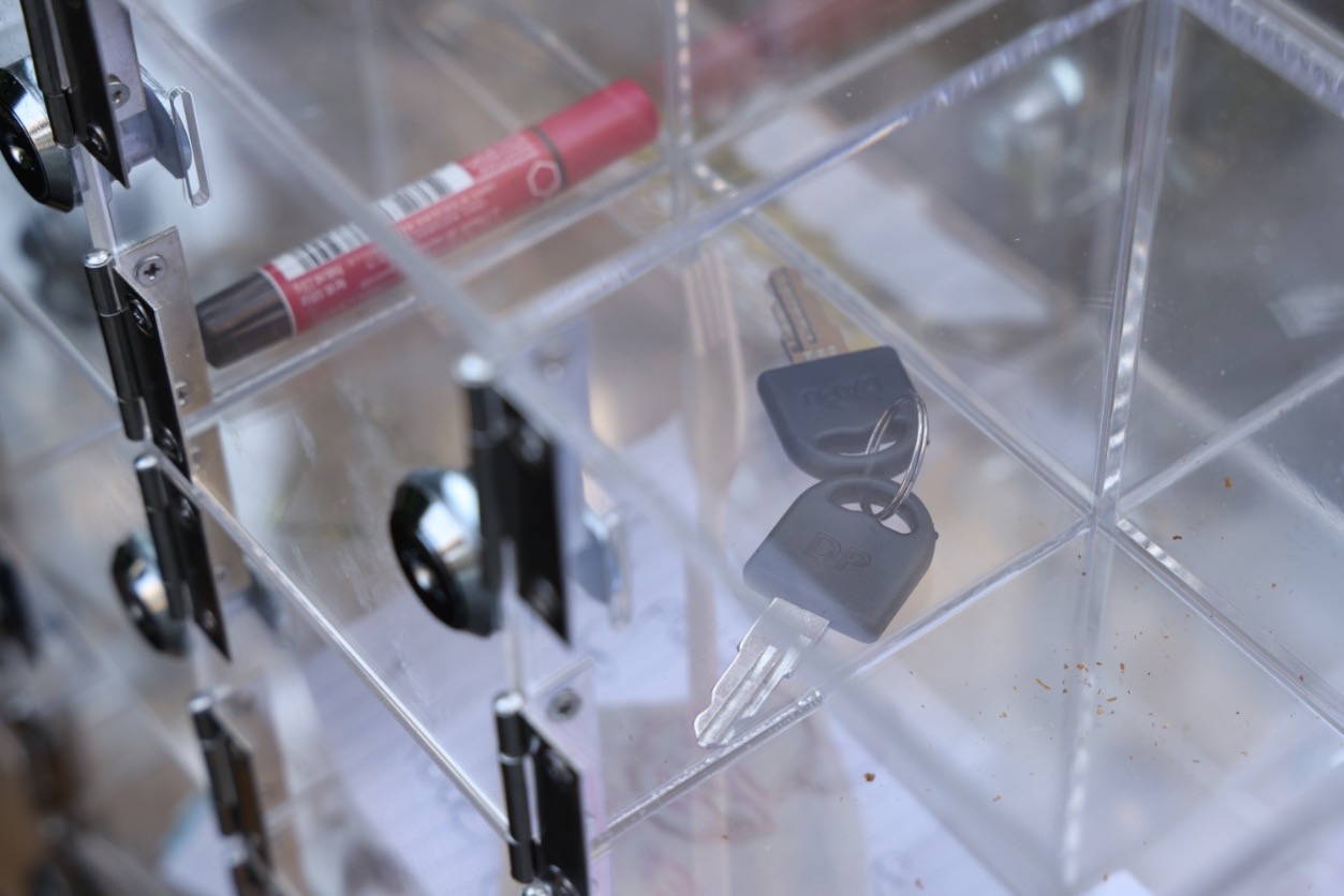An image of a air of keys locked in a perspex box.