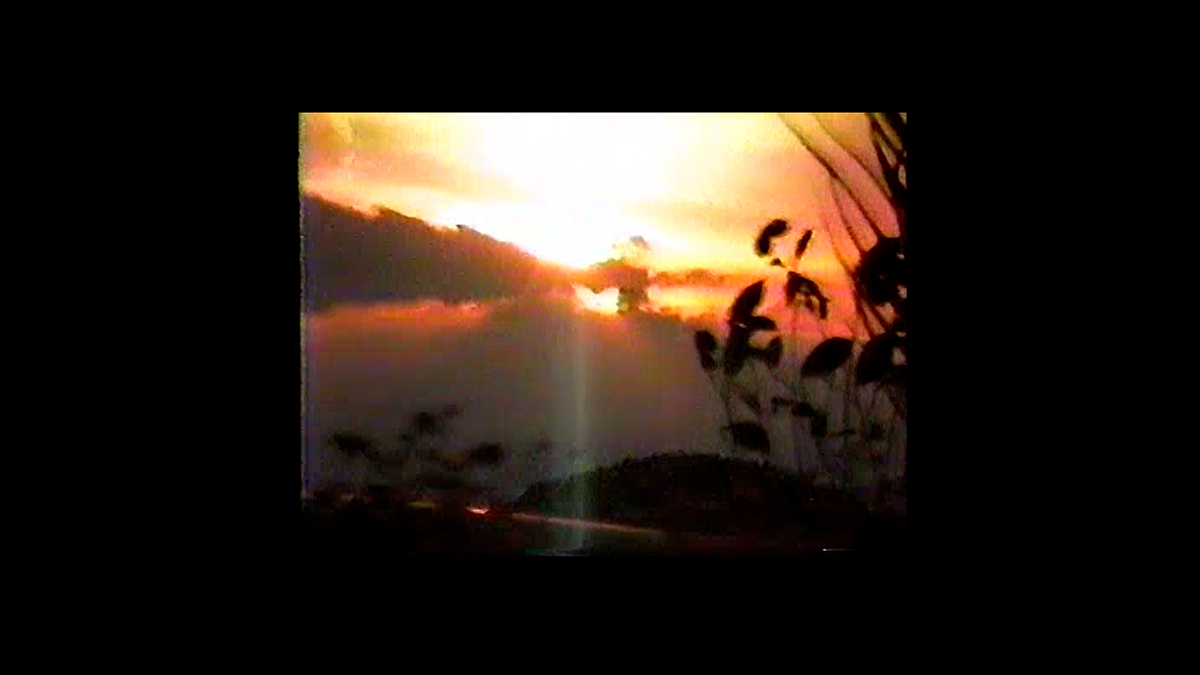 A video still of the sun bursting from behind some clouds.