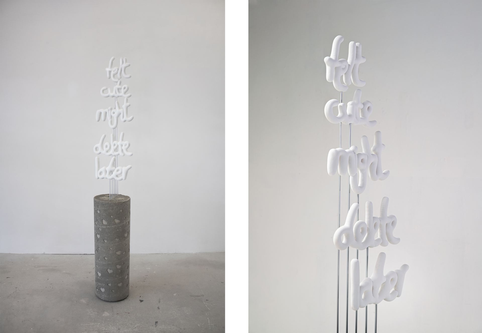 An image of balloon-shaped handwriting, 3d printed in white plastic, that reads “Felt cute might delete later”. It is attached by aluminium rods to a concrete plinth covered with debossed hearts.