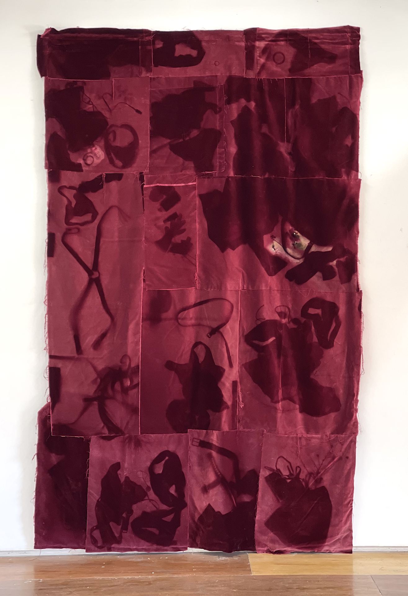 An image of a red velvet, patchwork curtain.