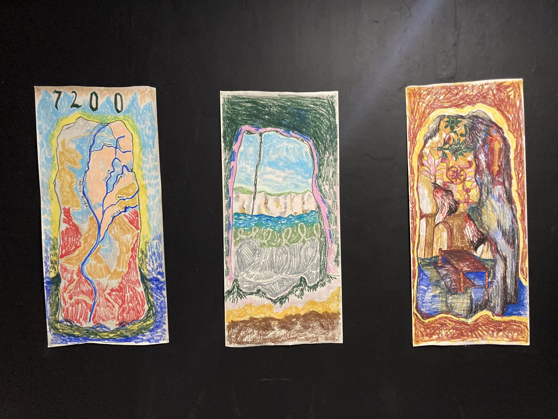 Three drawings in oil pastel on paper, one of rivers in Punjab, Pakistan with the number of glaciers in Pakistan written above in gothic font (left) white cliffs and English Channel with barbed wire (centre) and abstract woodcarving motifs (right).