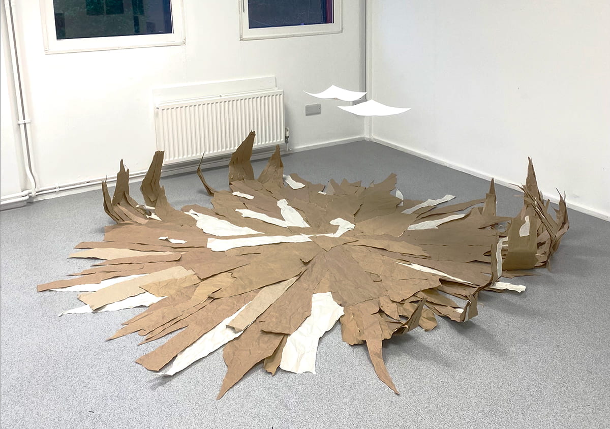 An image of a large, floor-based, flat cardboard sculpture.