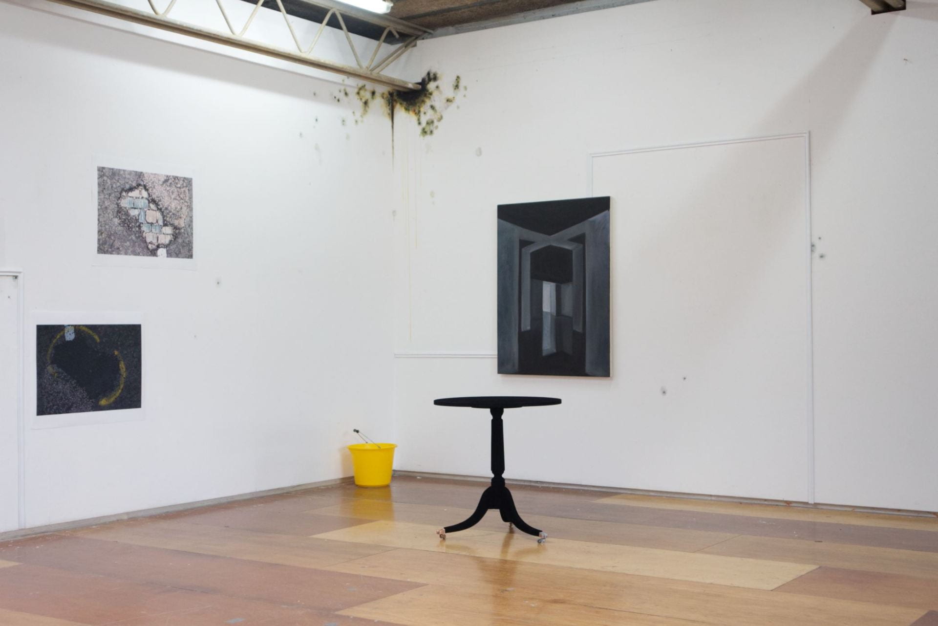 Installation shot of wall trim, hand-painted mould, oil painting, photographic prints, occasion table painted in Musou black and yellow bucket.