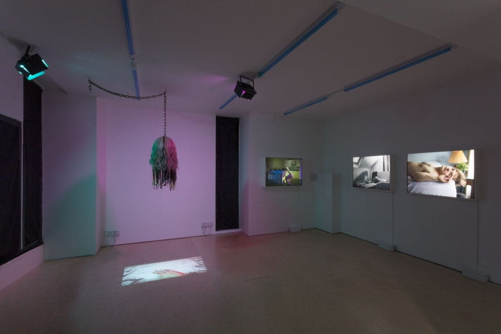 An exhibition of Liz Calvi's work at Seager space, showing four different films and a hanging sculpture.
