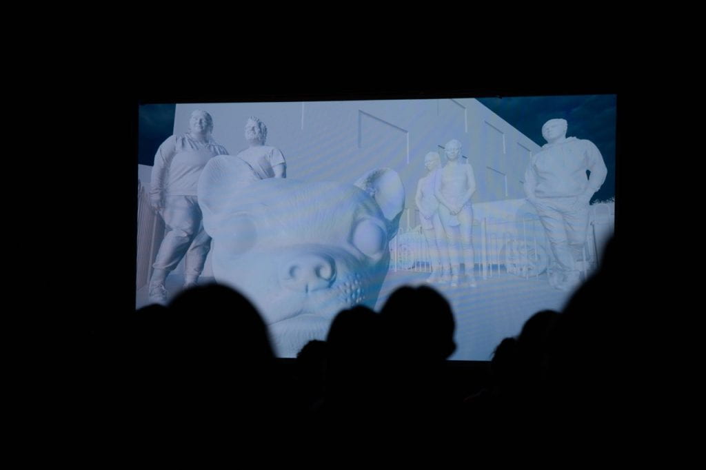 A still from a film shown at Set film festival, an animated dog stares at audiences with 5 other animated human figures standing in the background.