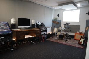 Goldsmiths Music Studio, Studio 3. Containing a small mixing desk, a drum kit and several guitar amps