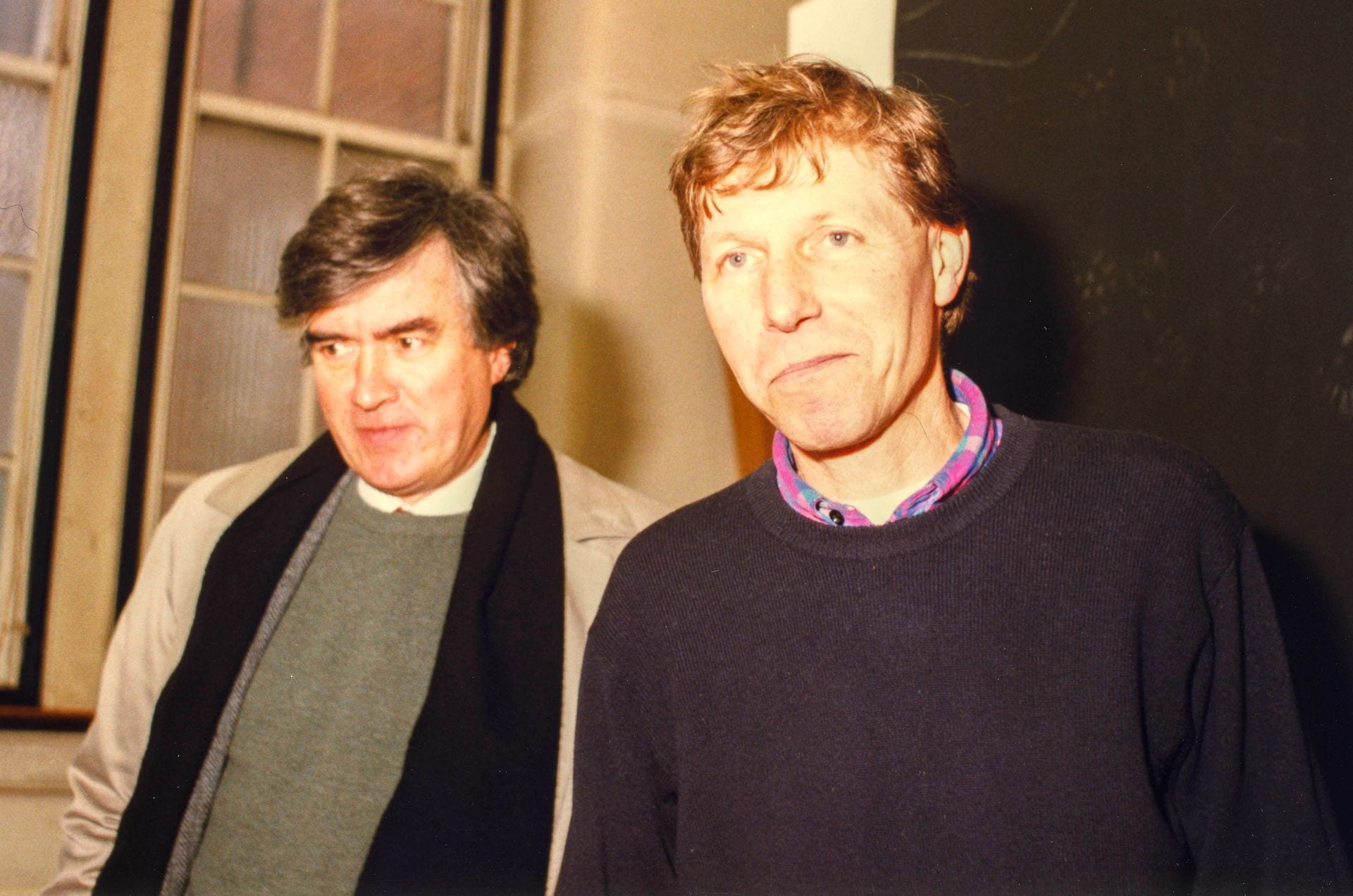 Portrait of Ian Jeffrey and Nigel Perkins together in Goldsmiths College main building studio in 1996. Ian is wearing a black scarf around his shoulders. Nigel is wearing a sweater. 