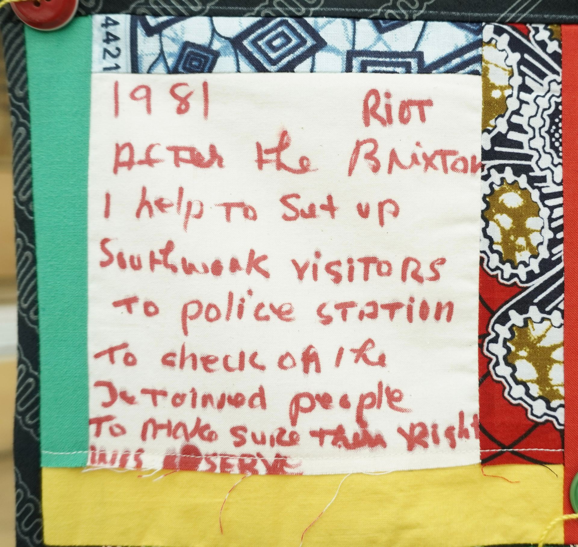 Commemorative quilt. Text reads, '1981 After the Brixton riot I help to setup Southwark visitors to police station to check on the detained people to make sure their right was reserved'