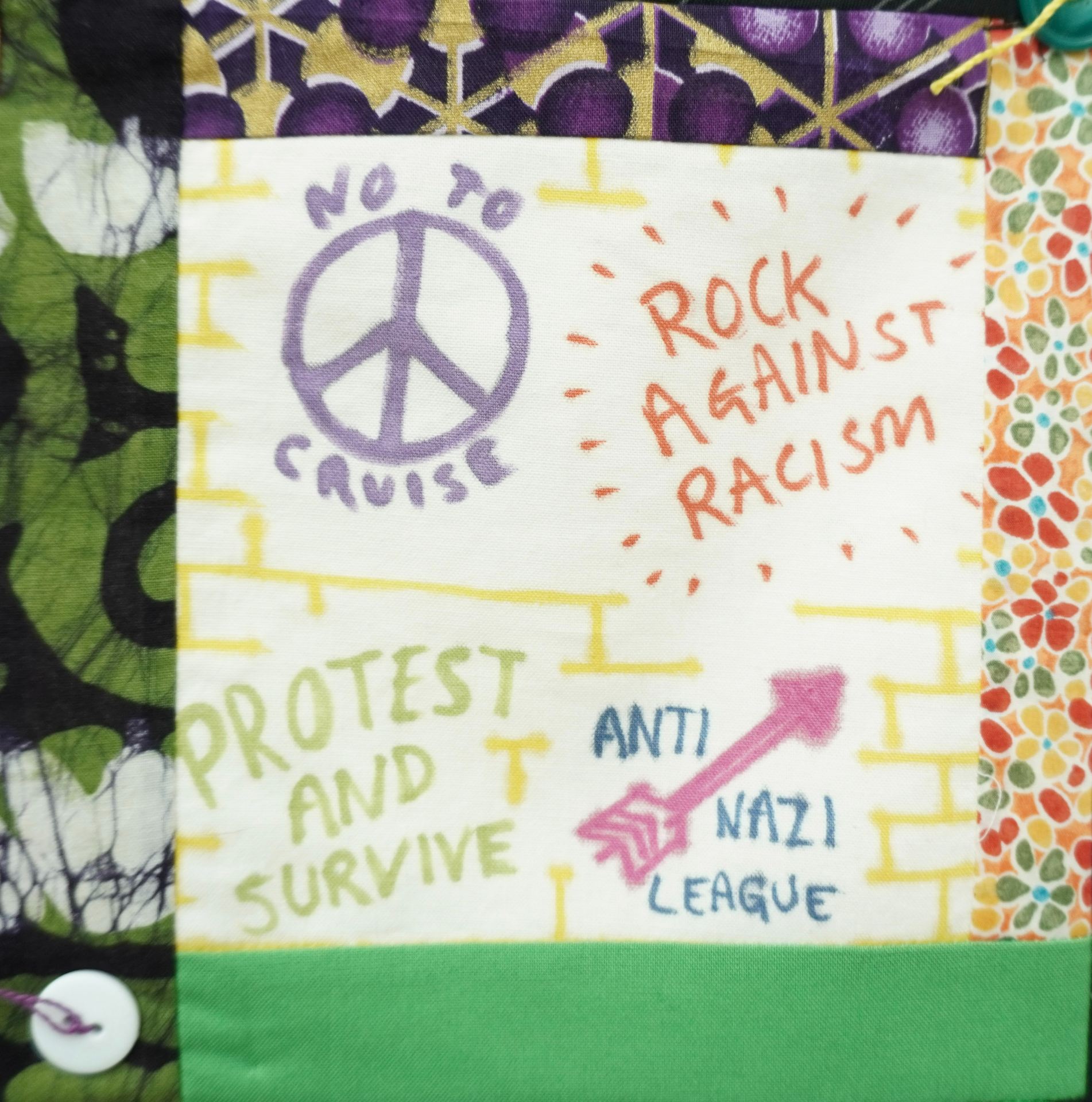 Commemorative quilt. Text reads, 'Rcok Against Racism, Protest and Survive, Anti-Nazi League'