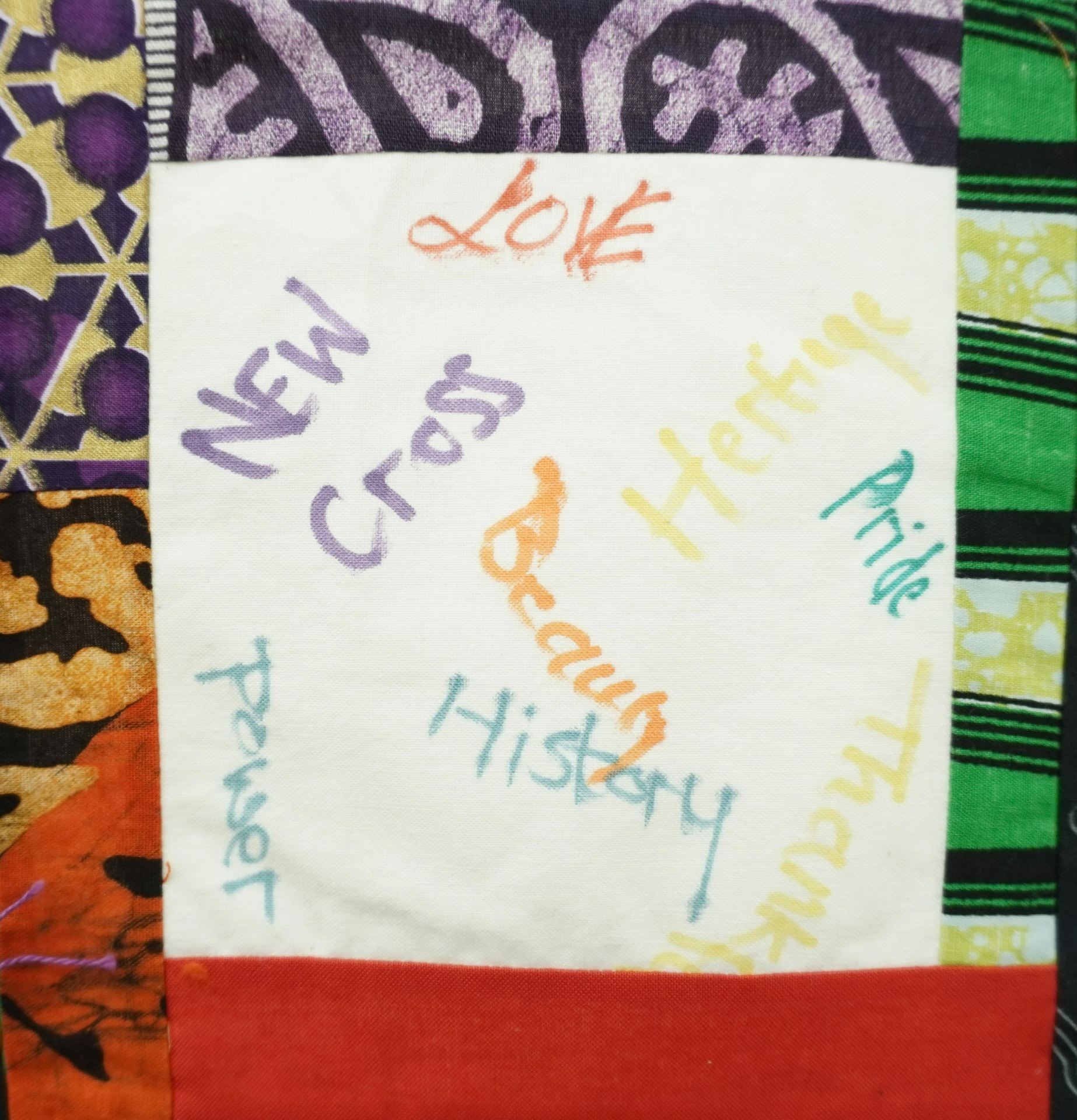 Commemorative quilt. Text reads, ' New Cross, love, pride, beauty, power, history, heritage, thankful' 