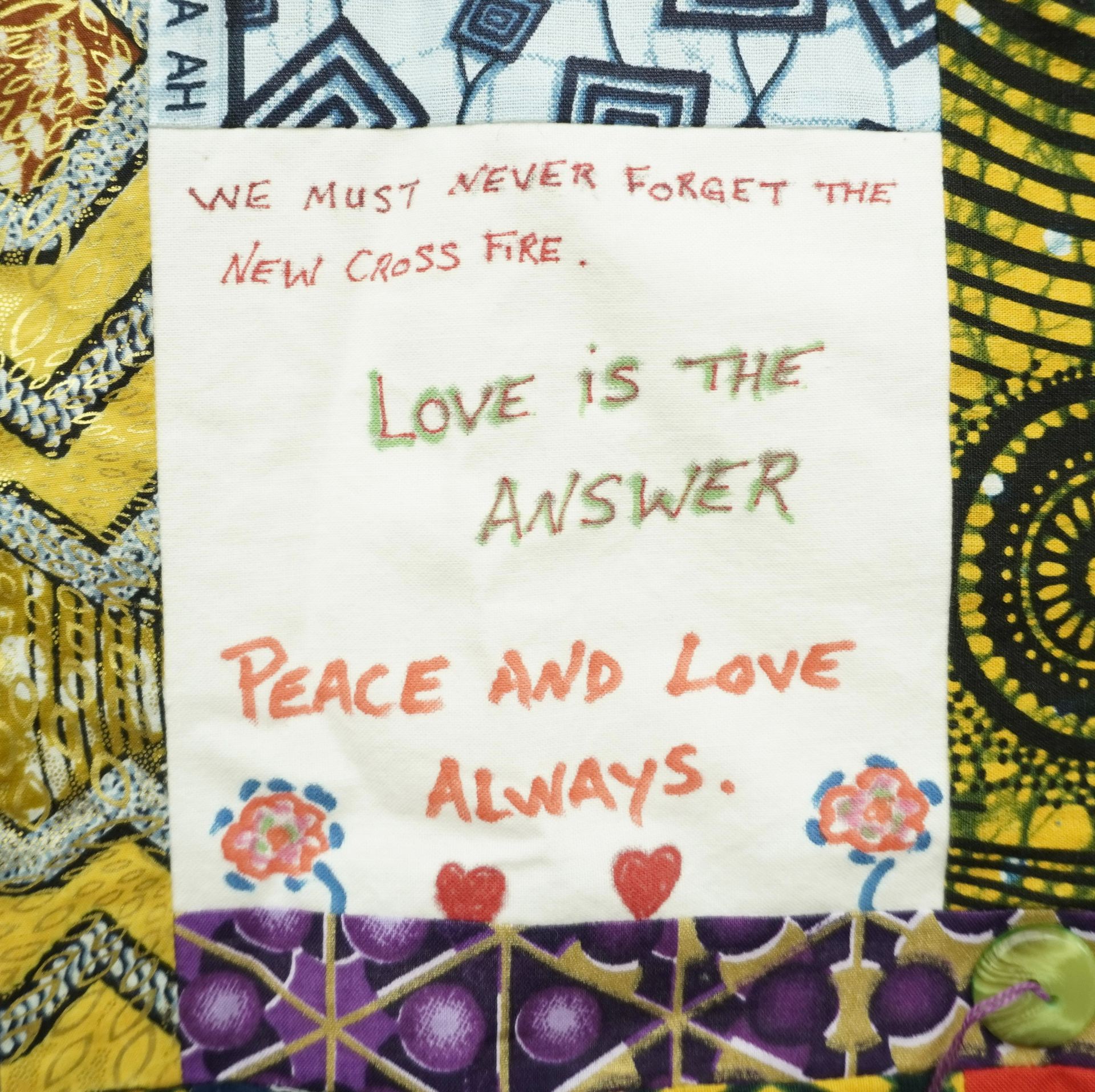 Commemorative quilt. Text reads, 'We must never forget the New Cross Fire. Love is the answer. Peace and love always'