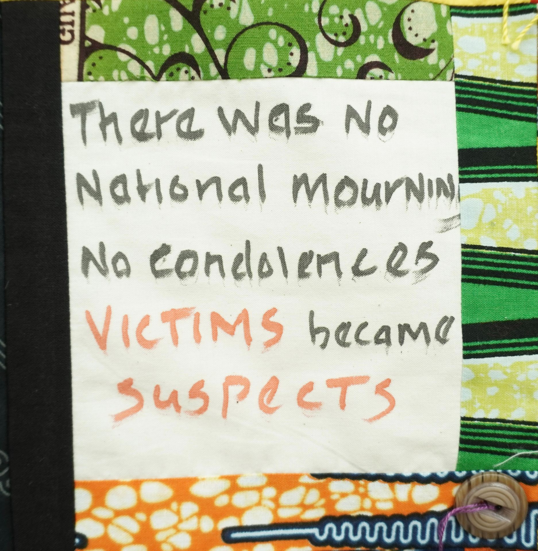 Commemorative quilt. Text reads, 'There was no national mourning, no condolences, victims became suspects'