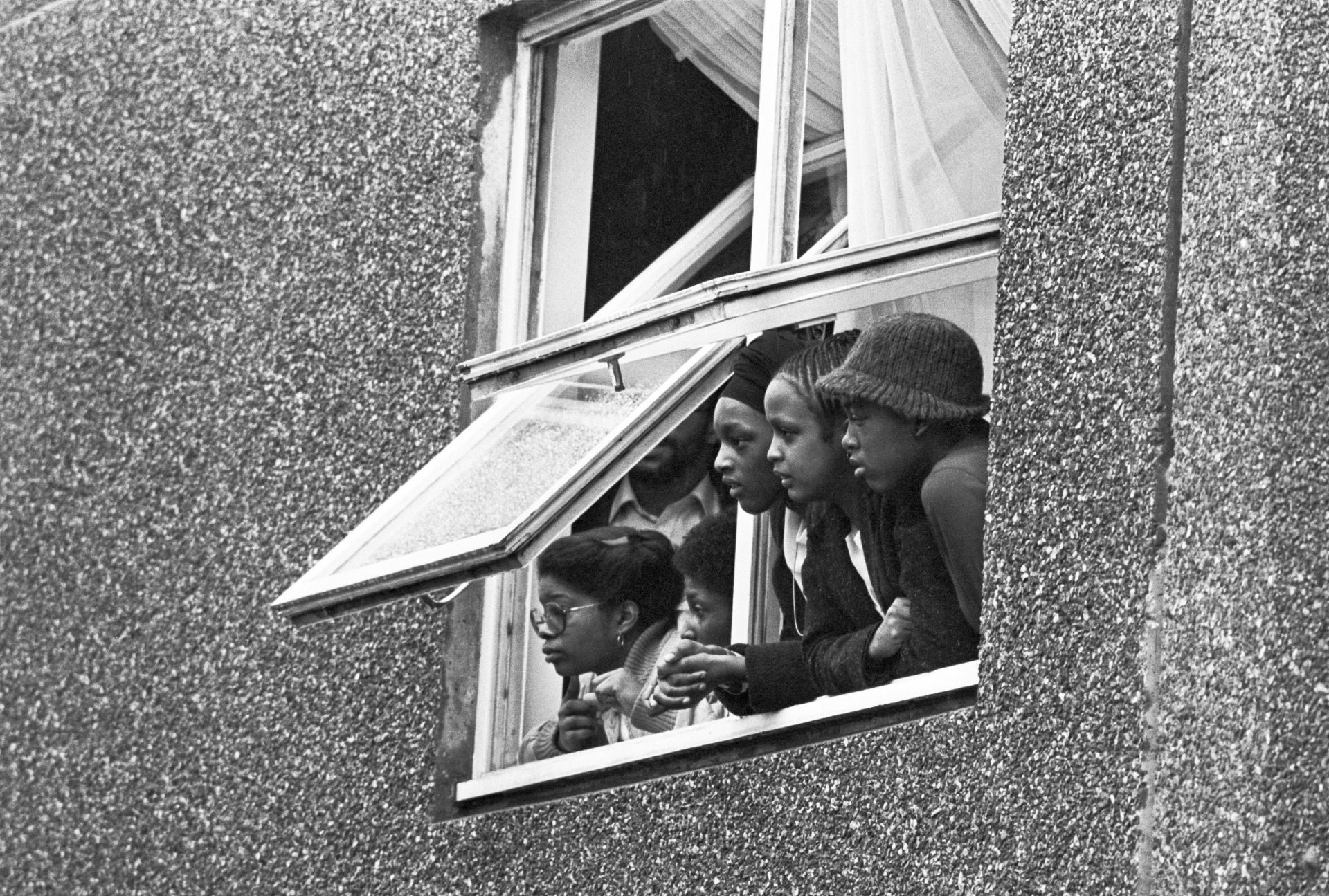 Young people leaning out of window