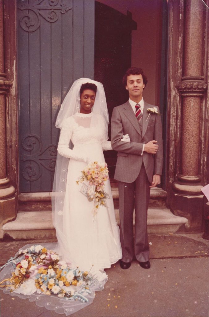 Man and woman stand outside a church on their wedding day