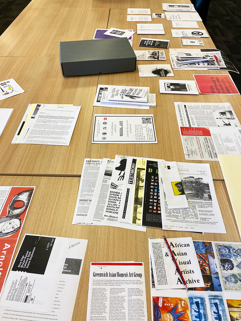 sheets of photocopied pamphlets and ephemera laid out on the table