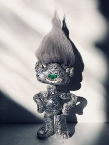 grey and silver sparkly troll sculpture